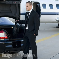 chauffeur pulling out luggage out of the trunk